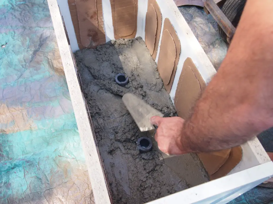 Once the bottom of the box was full right up to the top edge of the pipe insulation I put the inner box in place. I then filled up the sides. I used a small garden trowel to make sure I had the form full and packed tight.